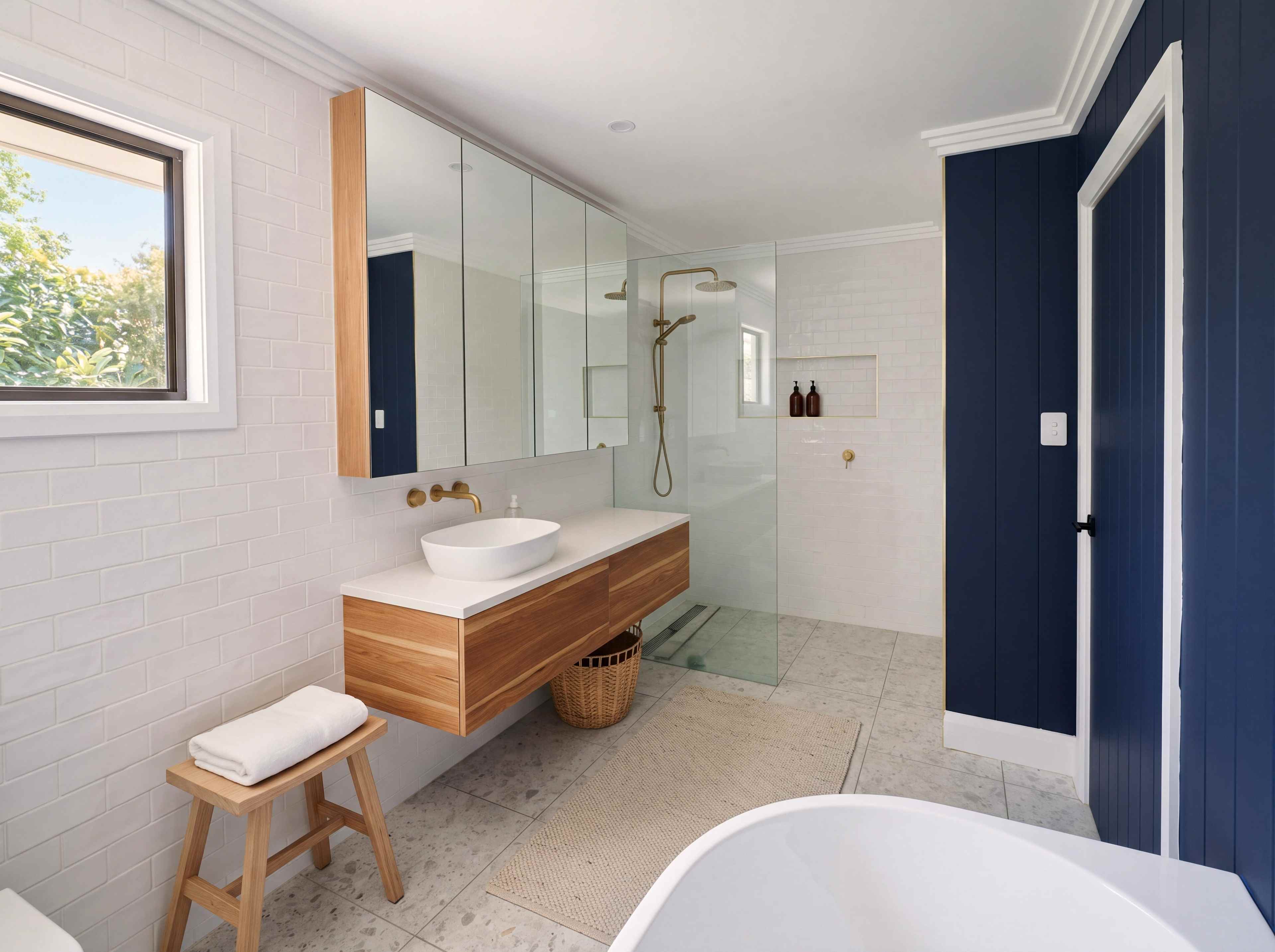 Main bathroom with white handmade tiles, a floating timber vanity, a frameless shower and a navy panelled wall