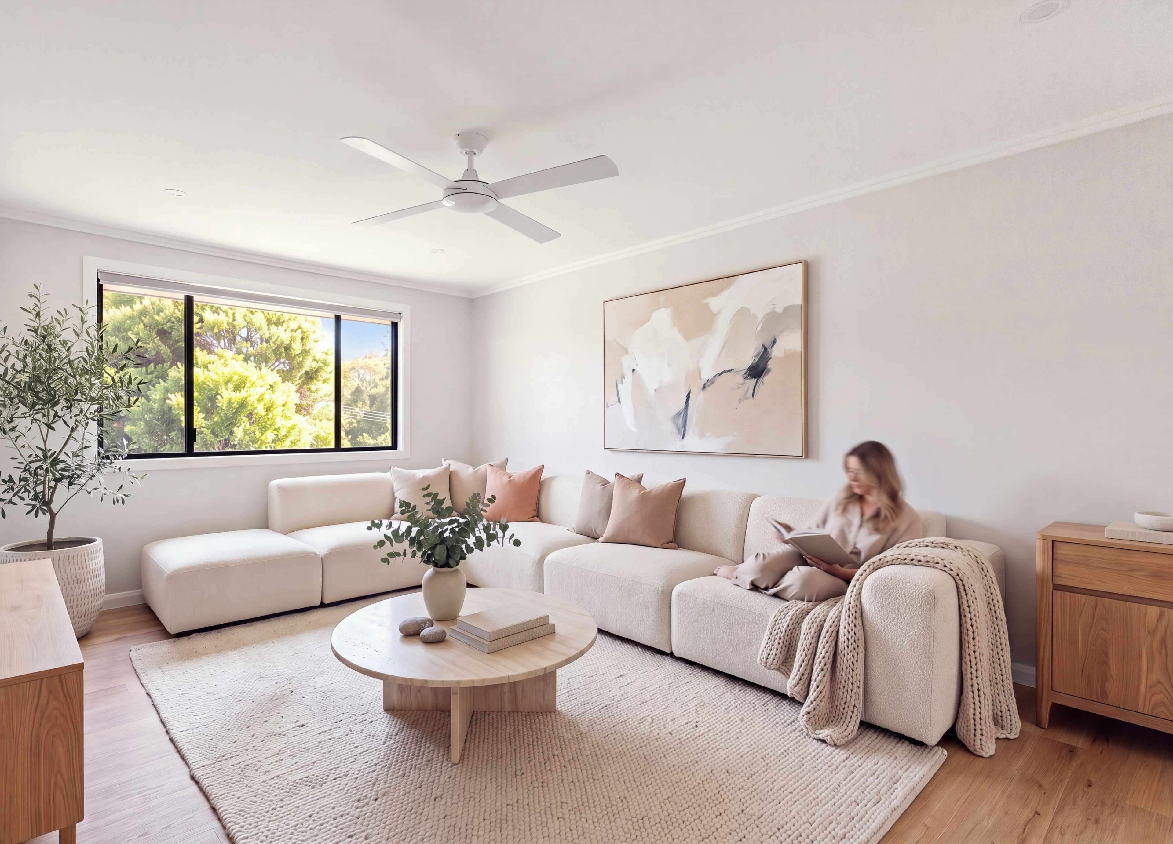 Living room with a cream modular sofa, an olive tree and soft daylight