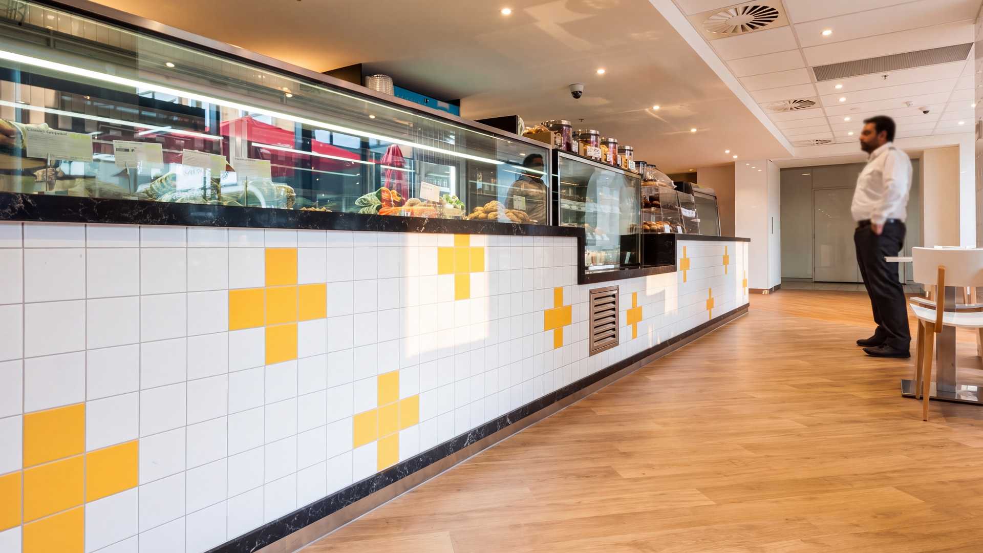 A newly fitted-out cafe with a long tiled counter patterned in yellow crosses